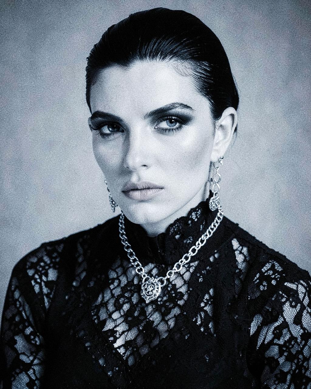 Black-and-white portrait of gothic model Vera Kohl in dark lace and silver jewelry